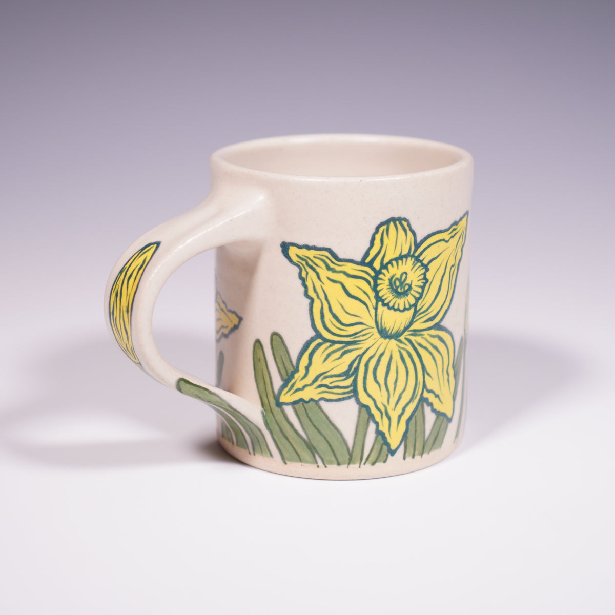 Wheel Thrown Ceramic Mug with Hand-Painted daffodil design. (Front View)