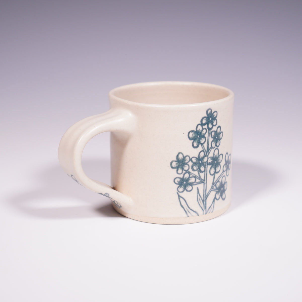 Wheel Thrown Ceramic Mug with Hand-painted Forget Me Nots Design. (Front View)