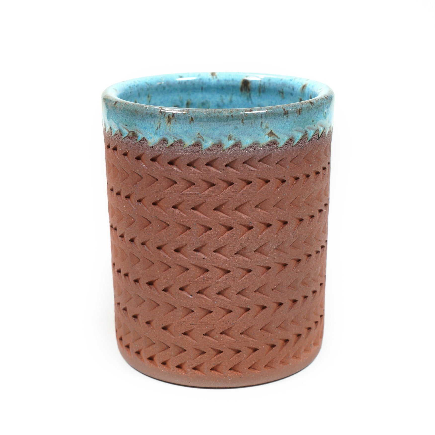 Wheelthrown red stoneware tumbler, adorned with textured motif. 