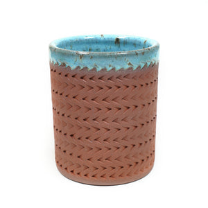 Wheelthrown red stoneware tumbler, adorned with textured motif. 