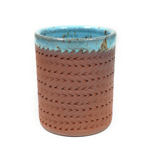 Wheelthrown red stoneware tumbler, adorned with textured motif.