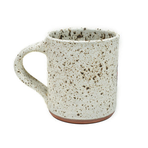 Wheelthrown red stoneware mug with a hand-painted mushroom motif & speckled white glaze 