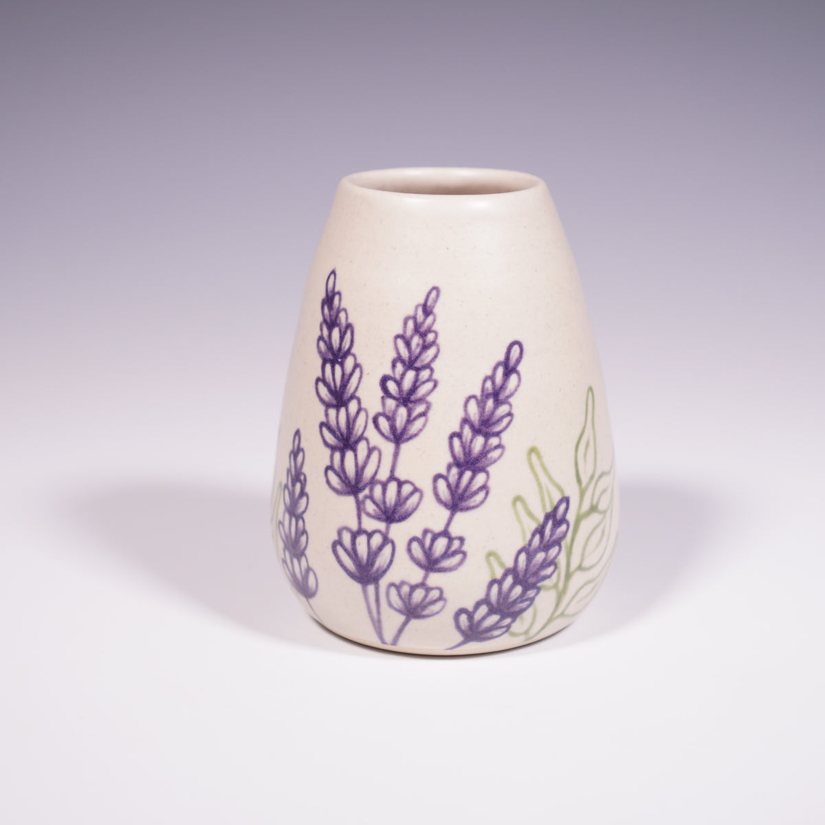 Wheel Thrown Ceramic Corked Jar with Hand-Painted Lavender Design. (Front View)