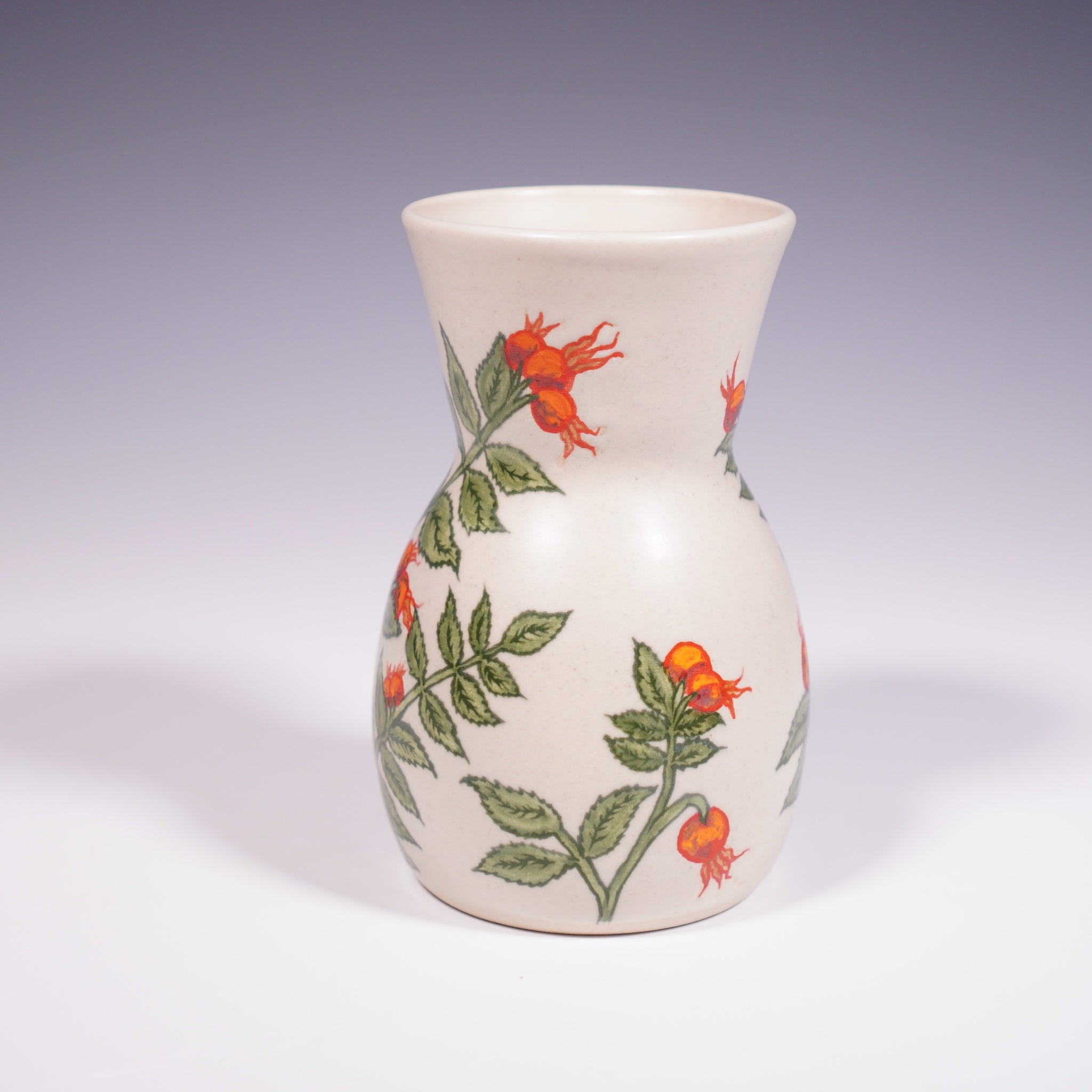 Wheel thrown ceramic vase with hand-painted rose hip underglaze design. (Back View)
