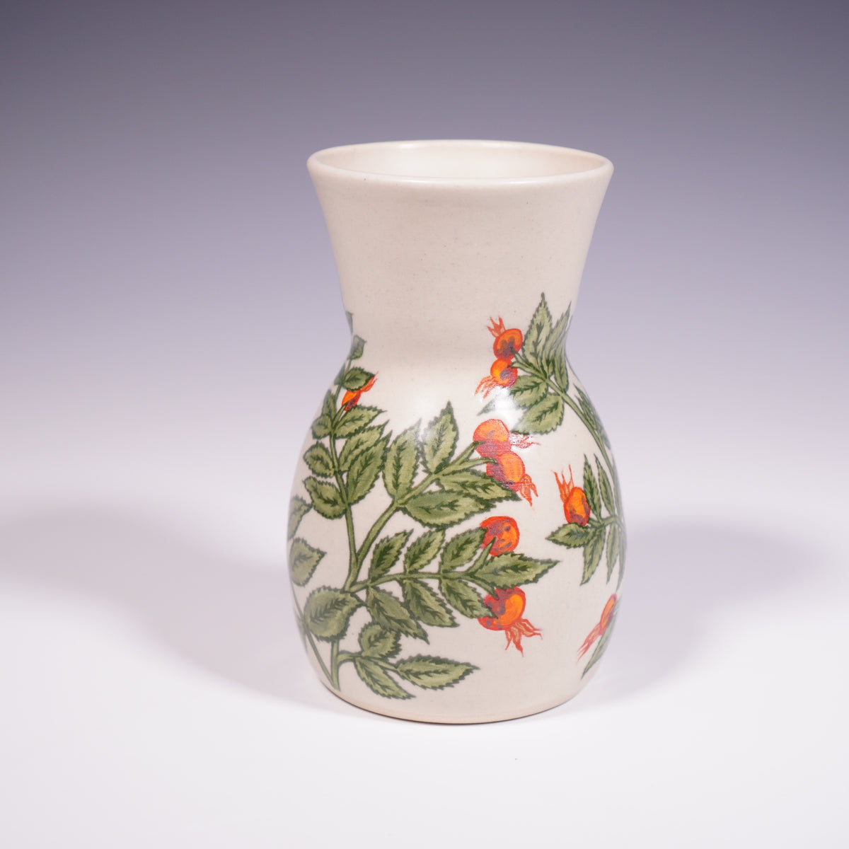 Wheel thrown ceramic vase with hand-painted rose hip underglaze design. (Front View)