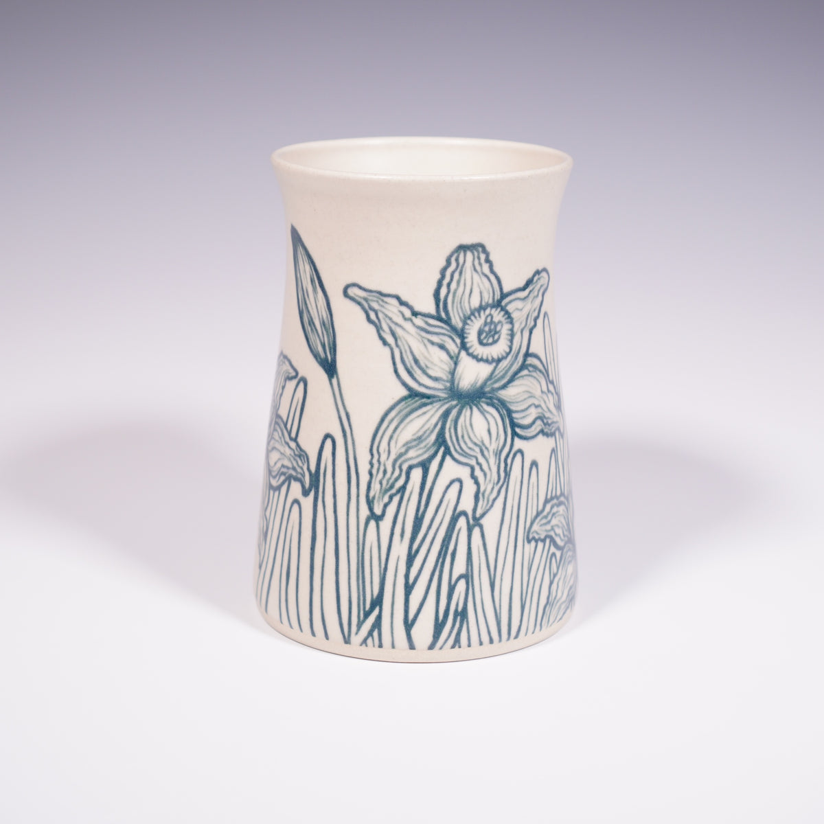 Wheel thrown ceramic vase with hand-painted daffodil underglaze design. (Front View)